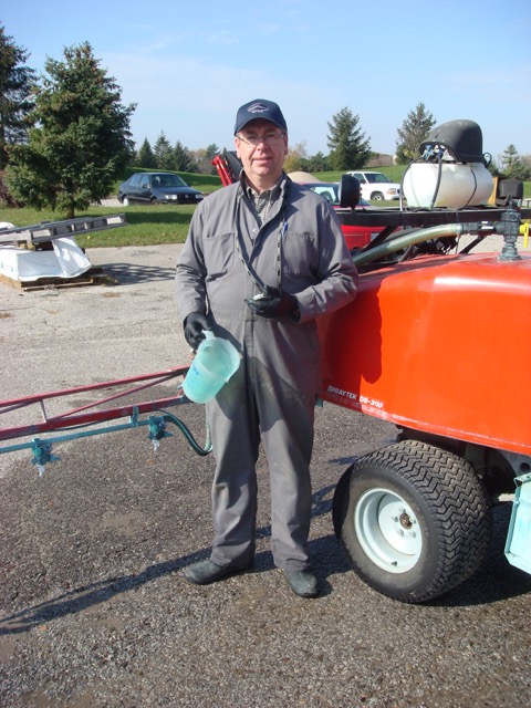 Wray standing next to a turf sprayer